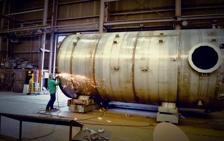 Man welding on API in plant